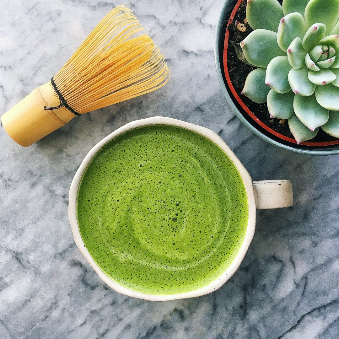 matcha latte with bamboo whisk, and succulent